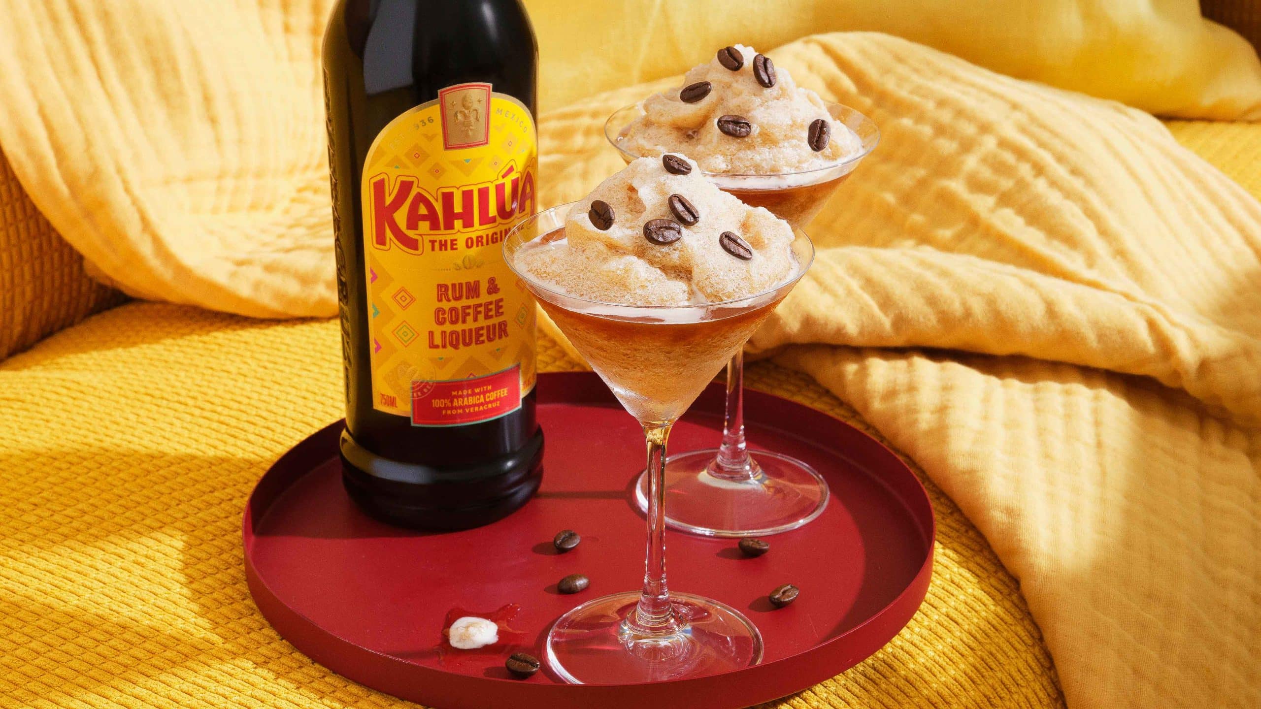 frozen espresso martini on a tray with a bottle of Kahlua