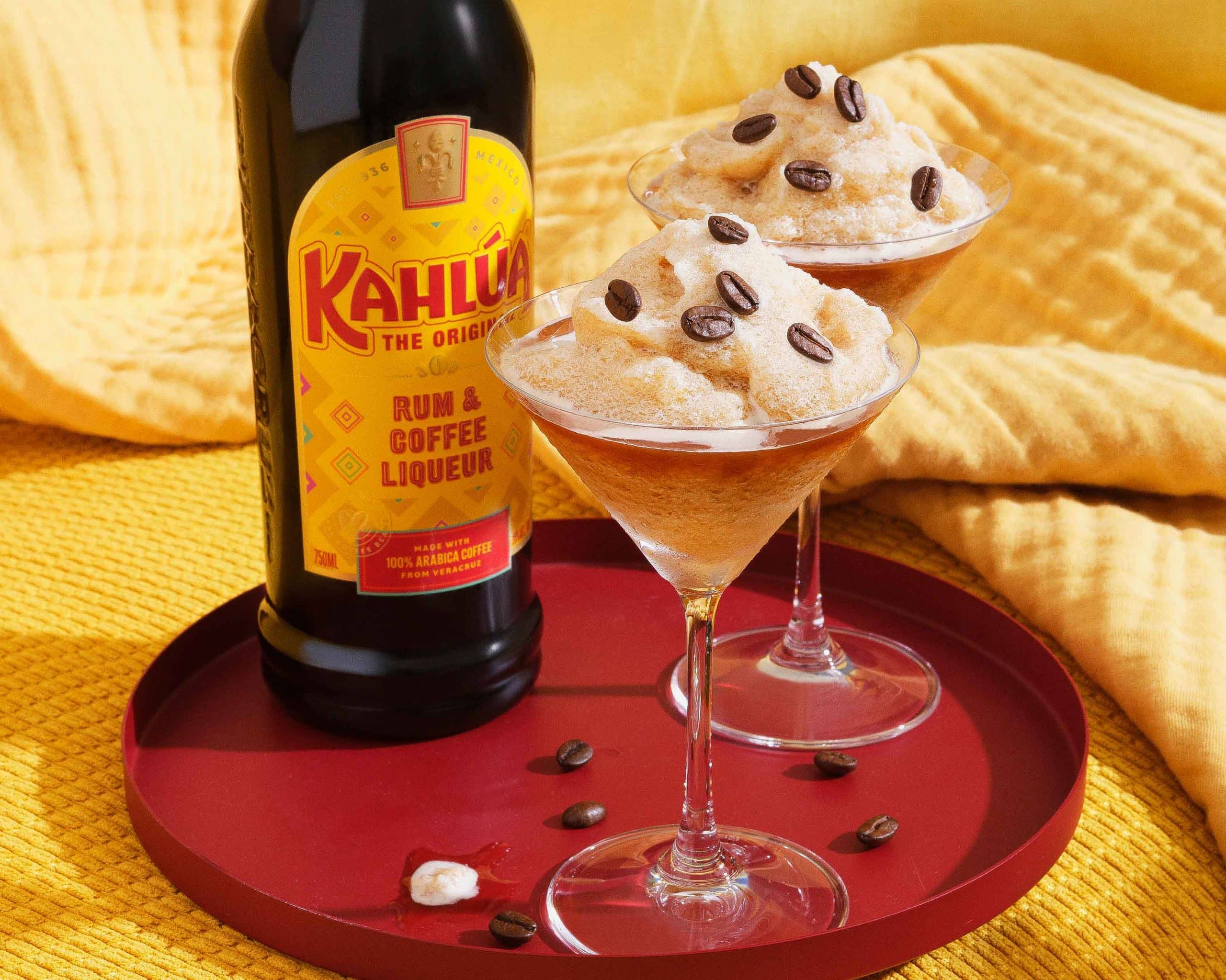 frozen espresso martini on a tray with a bottle of Kahlua