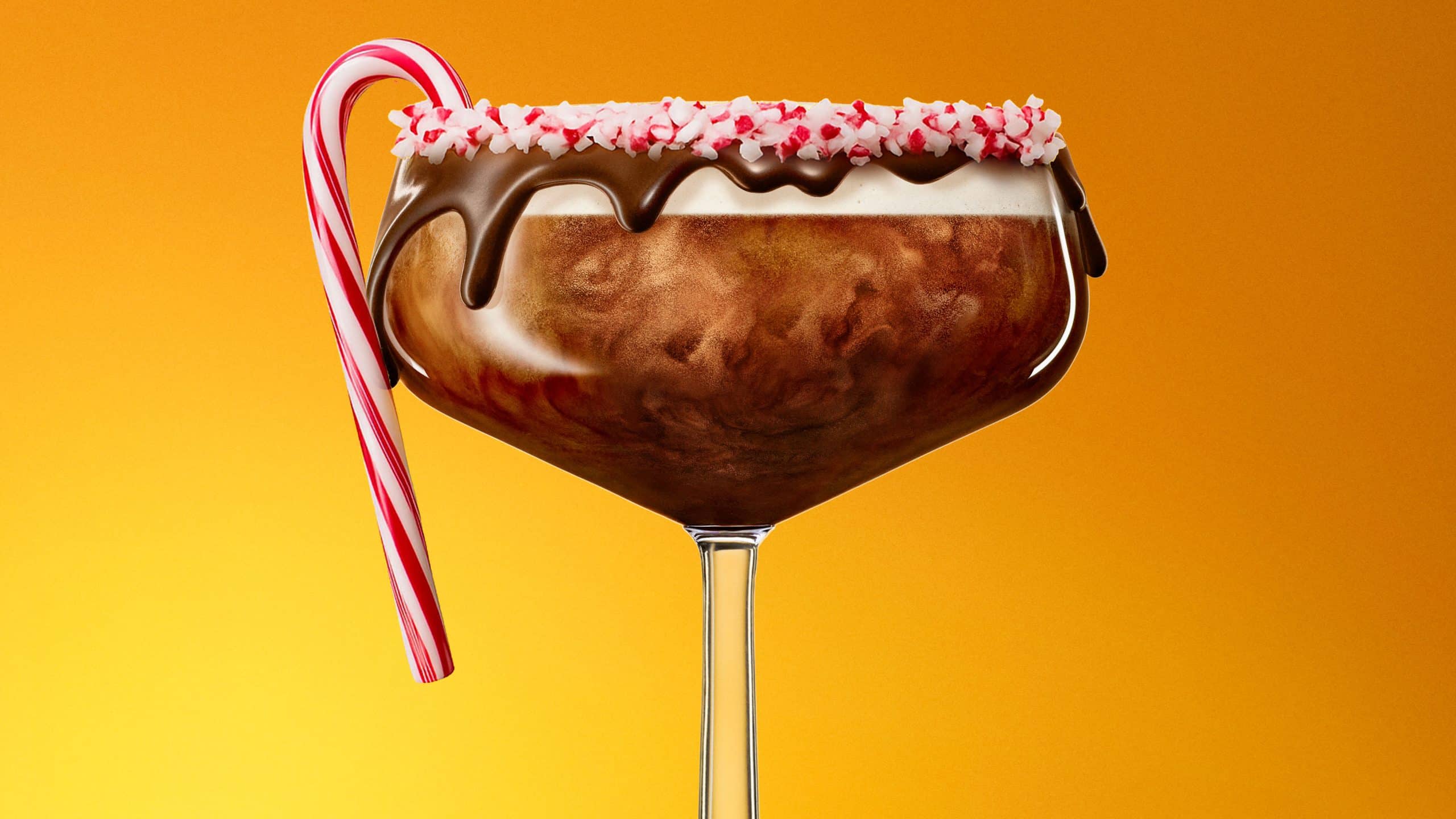One Chocolate Peppermint Martini cocktail garnished with chocolate rim and a candy cane on the side in front of a yellow background